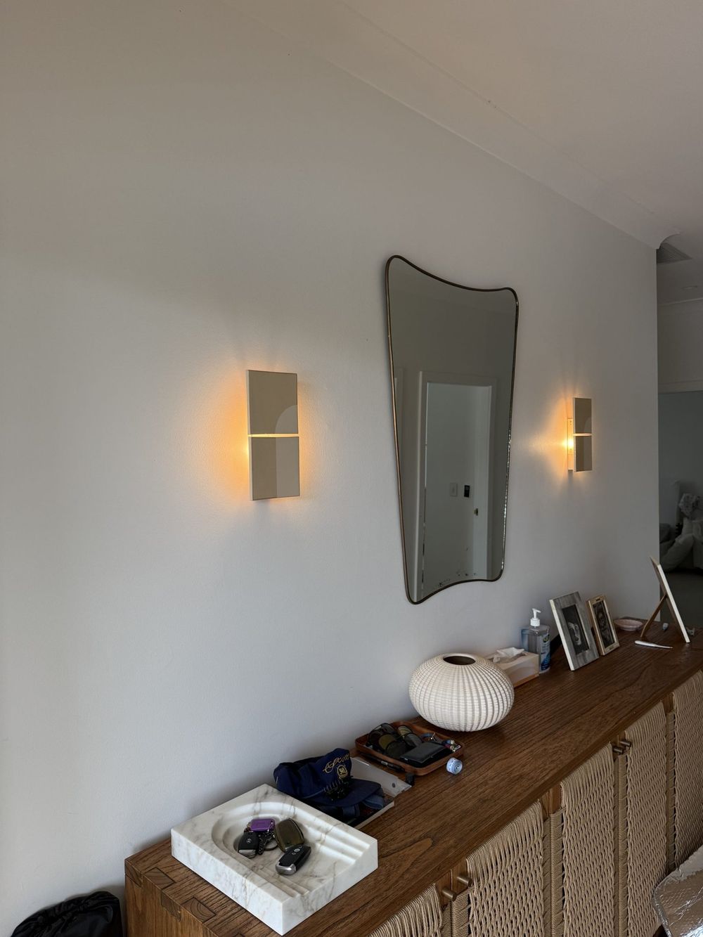 Wall sconces lighting a hallway console